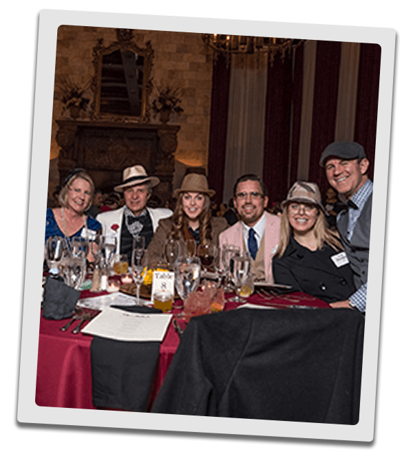 Dallas Murder Mystery party guests at the table
